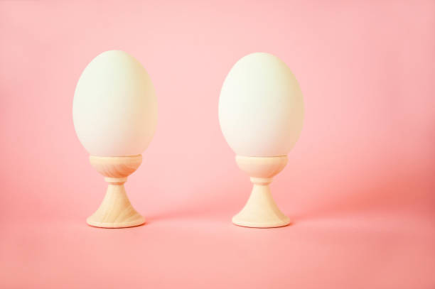istock Two eggs on stands on a pink background close-up and copy space. Two eggs, easter concept, 1137380508