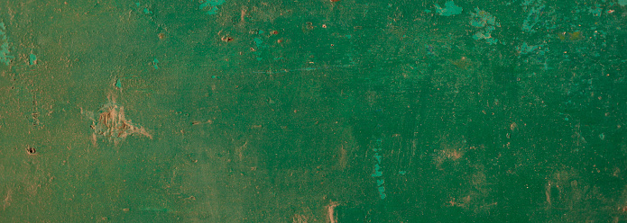Macro image of a freshly installed dark green chipboard wall, stained dark blue.