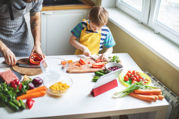 istock Father and son preparing food 1137384704