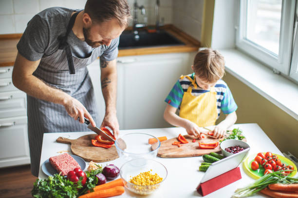 istock Father and son preparing food 1137384710