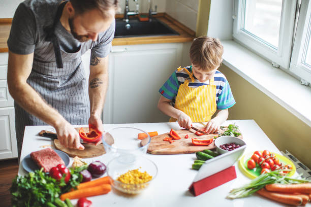 istock Father and son preparing food 1137384716