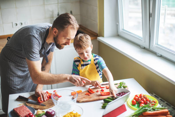 istock Father and son preparing food 1137384719