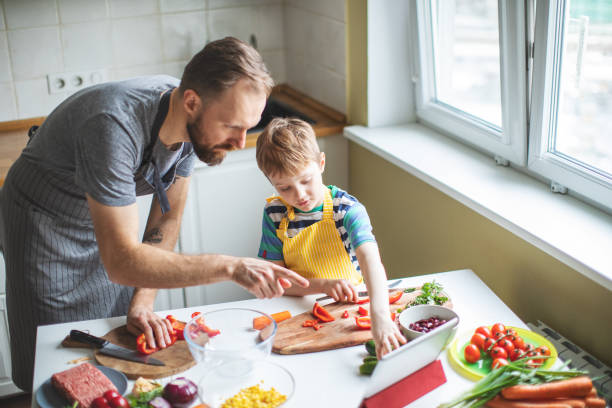 istock Father and son preparing food 1137384726