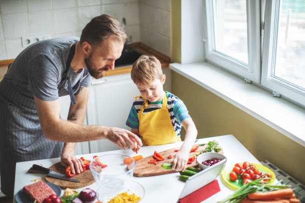 istock Father and son preparing food 1137384732