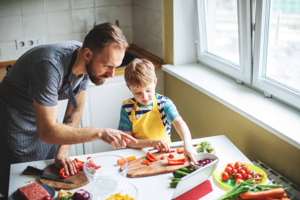 istock Father and son preparing food 1137384750