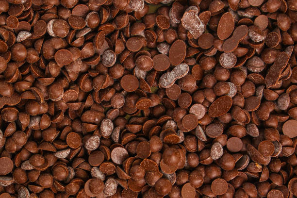 istock chocolate drops (sweets). food background. copy space. top 1137385487