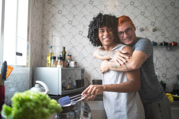 istock Young gay couple cooperating while cooking portrait 1137386039