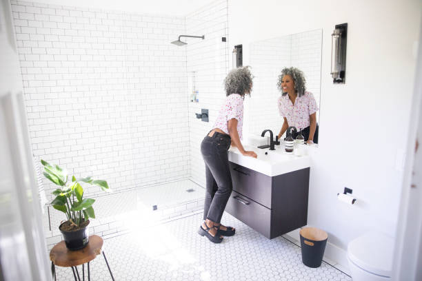 istock Beautiful Black Woman Putting on Makeup 1137386950