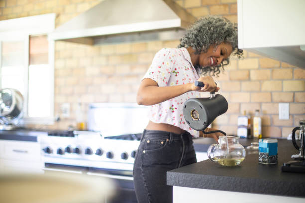 istock Black Woman Pouring Tea in Kitchen 1137387009