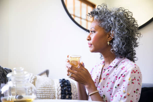 istock Black Woman with cup of tea relaxing 1137387236