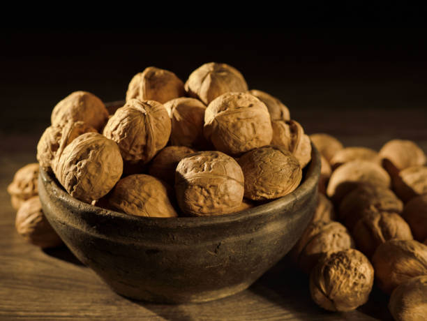 istock Walnuts in the Bowl lie on a wooden table 1137387528