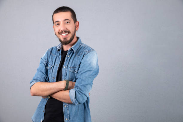 istock young and sport dressed man smile over gray background 1137390408