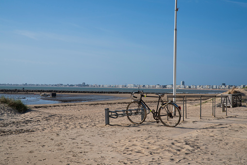 A bike in front of a sandy beach in La Baule and Pornichet in Brittany