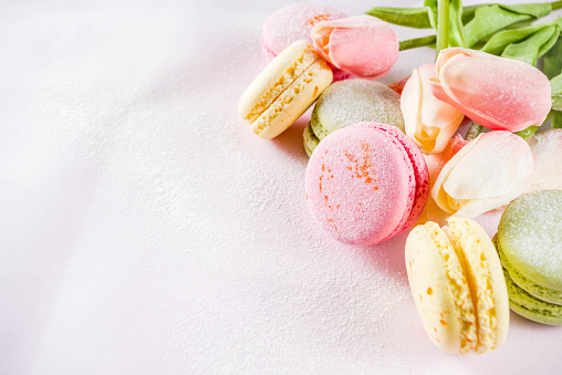 Classic colorful macarons. Six pink, yellow and green macaron cookies top view copy space