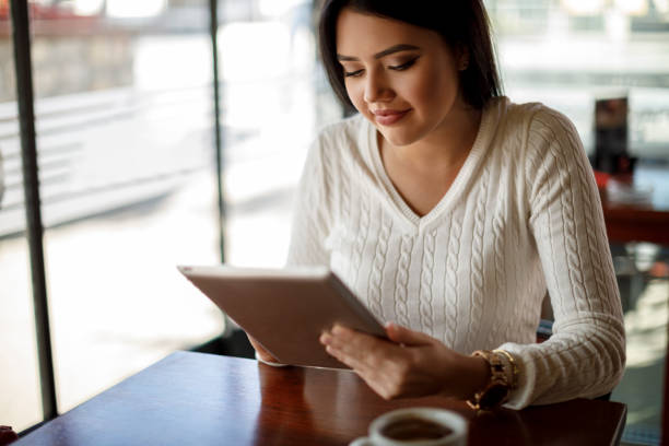 istock Young woman using digital tablet at a cafe 1137393345