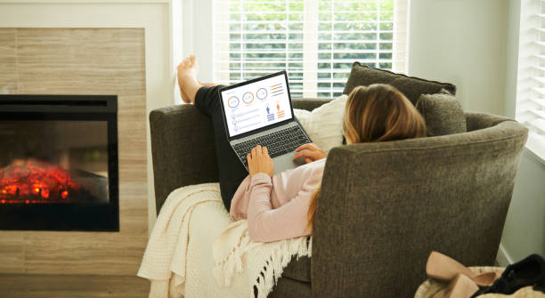 taking advantage of her newly bought wifi package - lying down women laptop freedom imagens e fotografias de stock