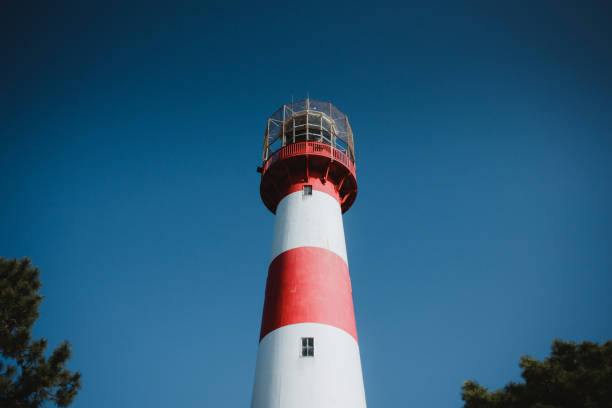 istock Red and white lighthouse on the background of a blue sky 1137397580