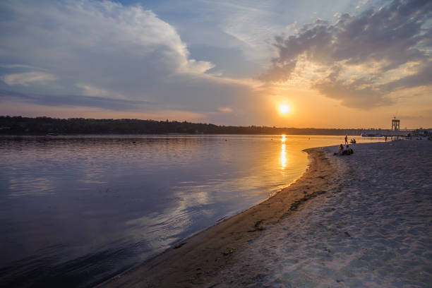 istock People walk along the river in the highlight of the setting sun 1137397909