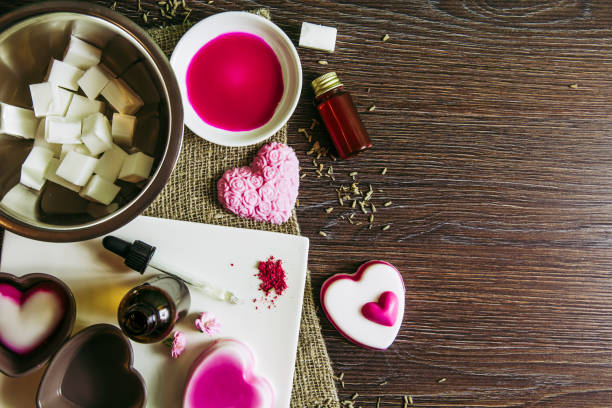 istock Making soap from pour and melt soap base concept. Soap making ingredients on brown wooden background. melt and pour method, buy a soap base that’s already been made and cured. Flat lay view. Hobby. 1137398834