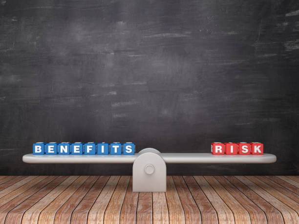 Seesaw Scale with BENEFITS RISK Cubes on Chalkboard Background - 3D Rendering stock photo