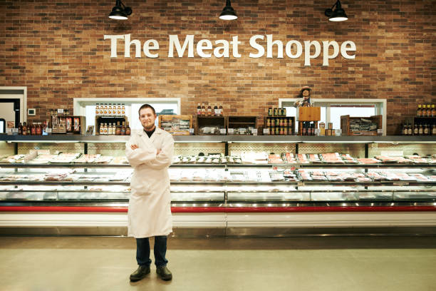 we've got all kinds of meat to match your mood - supermarket meat store manager imagens e fotografias de stock