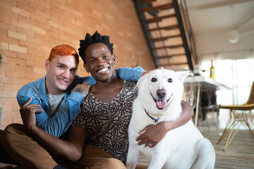 Gay Couple with Berger Blanc Suisse Dog at Home