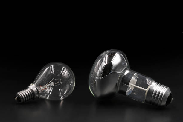 istock Two types of light bulbs on black background with copy space 1137404637