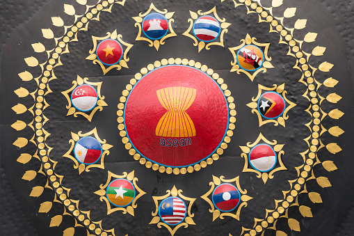 Phnom Penh, Cambodia - January 12, 2019: a close-up of a gong decorated with the emblem of ASEAN and the flags of ASEAN countries placed in the yard of Wat Ounalom Monastery.