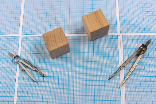 Millimeter paper with draw tools and wooden blocks