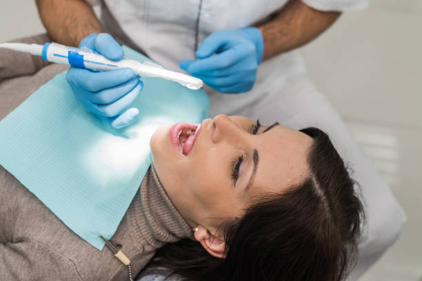 dentist checking patient's teeth with camera in stomatology - medical exam dental hygiene caucasian mask imagens e fotografias de stock