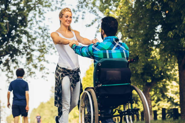 istock Paraplegic with her girlfriend on track in an open park 1137409761