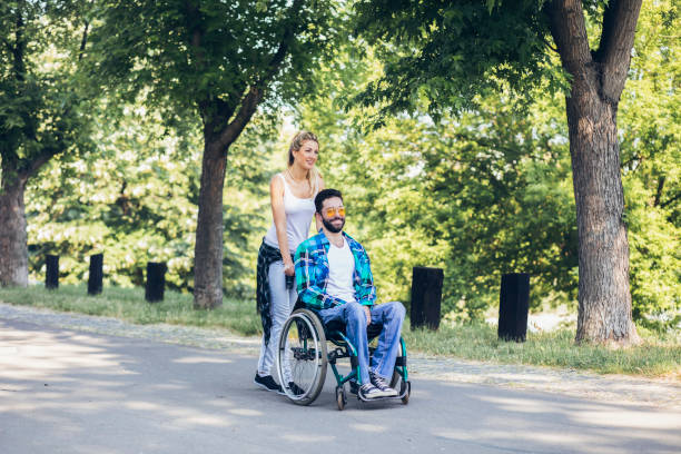 istock Paraplegic with her girlfriend on track in an open park 1137410337