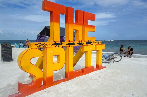 Caye Caulker, Belize - December 30, 2018: Big Sign on the Beach near Narrow Waterway that divides the Caribbean Island in two parts
