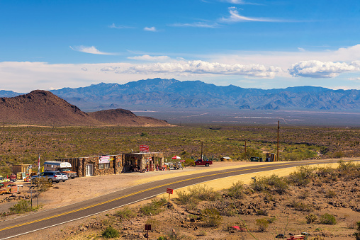 In Valley of Fire the road is winding and running through the red rock desert landscape. Seen in Nevada, USA, a hot day in the summer.