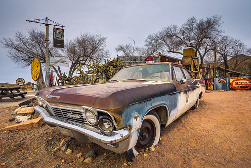 Hackberry, Arizona, USA - January 2, 2018 : Old sheriff's car wreck with a siren left abandoned near the Hackberry General Store. Hackberry General Store is a famous stop on the historic Route 66.