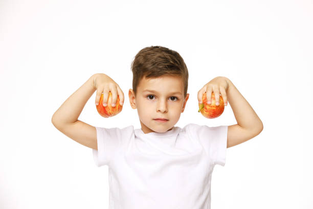 little boy is holding  apples studio sho - studio sho imagens e fotografias de stock