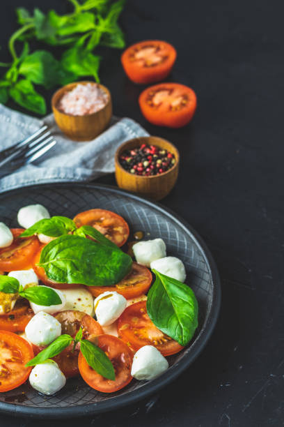 istock Italian caprese salad in black ceramic plate 1137421612
