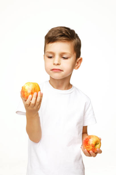 little boy is holding  apples studio sho - studio sho imagens e fotografias de stock