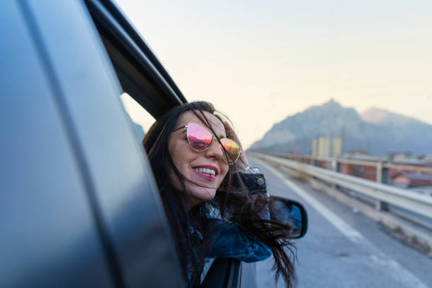 istock Young woman inside a car with the window open looking away 1137425627