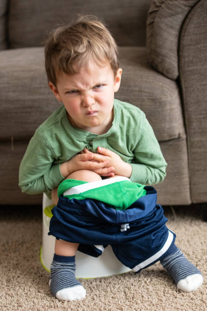 Constipated Three years old sitting in his potty Caucasian Three years old sitting in his potty expressing constipation potty toilet child bathroom stock pictures, royalty-free photos & images