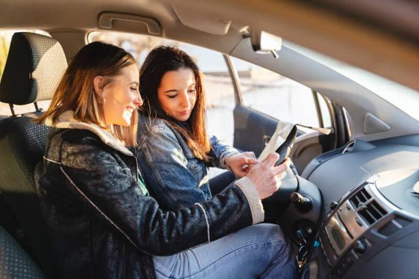 istock young women looking map in the car, view through the open side window 1137426867