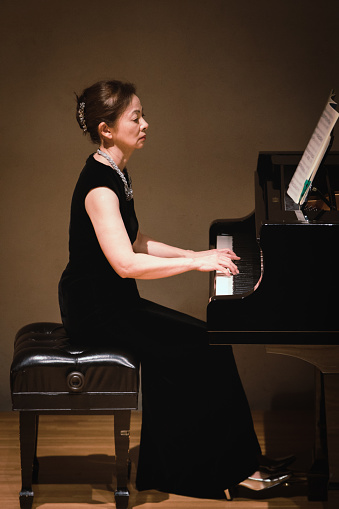 Woman playing piano at classical music concert