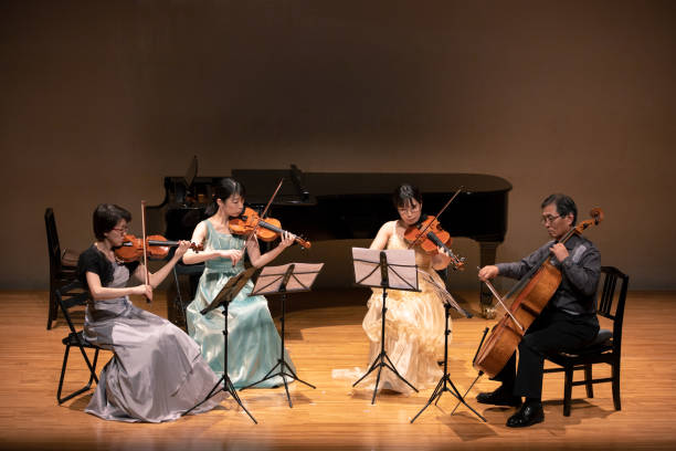 istock Violinists and cellist playing at classical music concert 1137429012