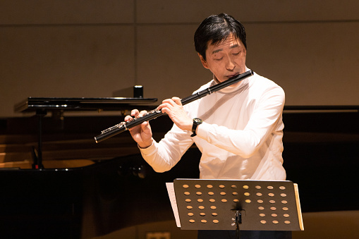 Playing flute at classical music concert