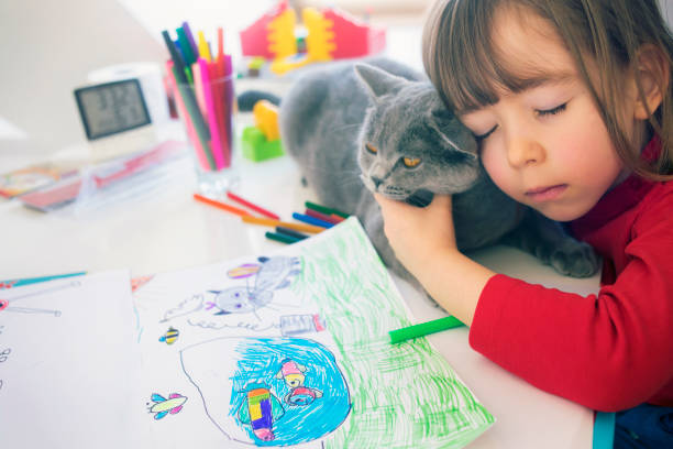 istock Child with kitty drawing at home 1137432908