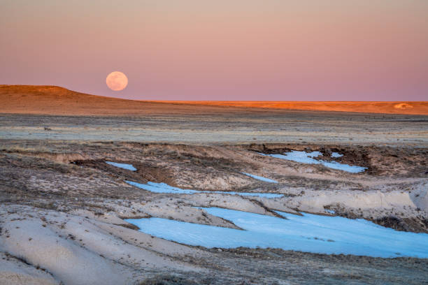 istock Sunset and moon rise over prairie 1137432925