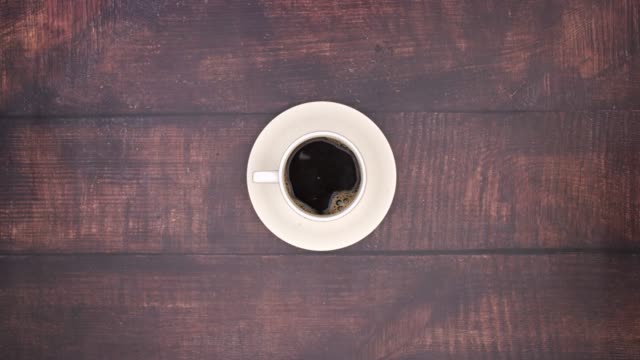 White cup filling with coffee - Stop motion