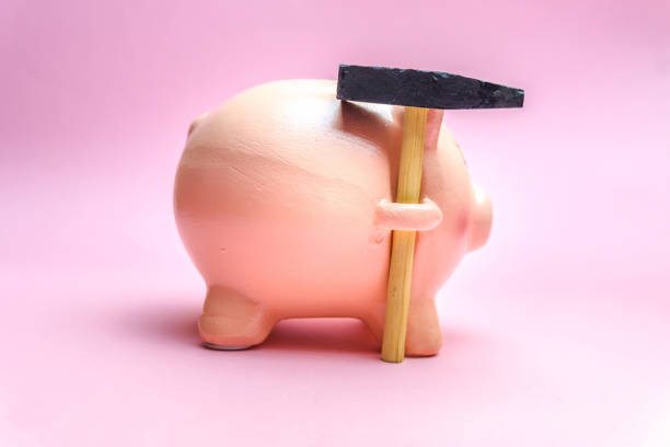istock Piggy Bank with small Hammer isolated on pink 1137436794