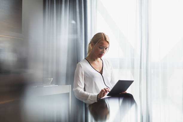 istock business lady in blouse sitting  and using digital tablet in hotel room 1137440095