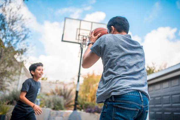 istock Father and son with arms raised playing basketball 1137444166